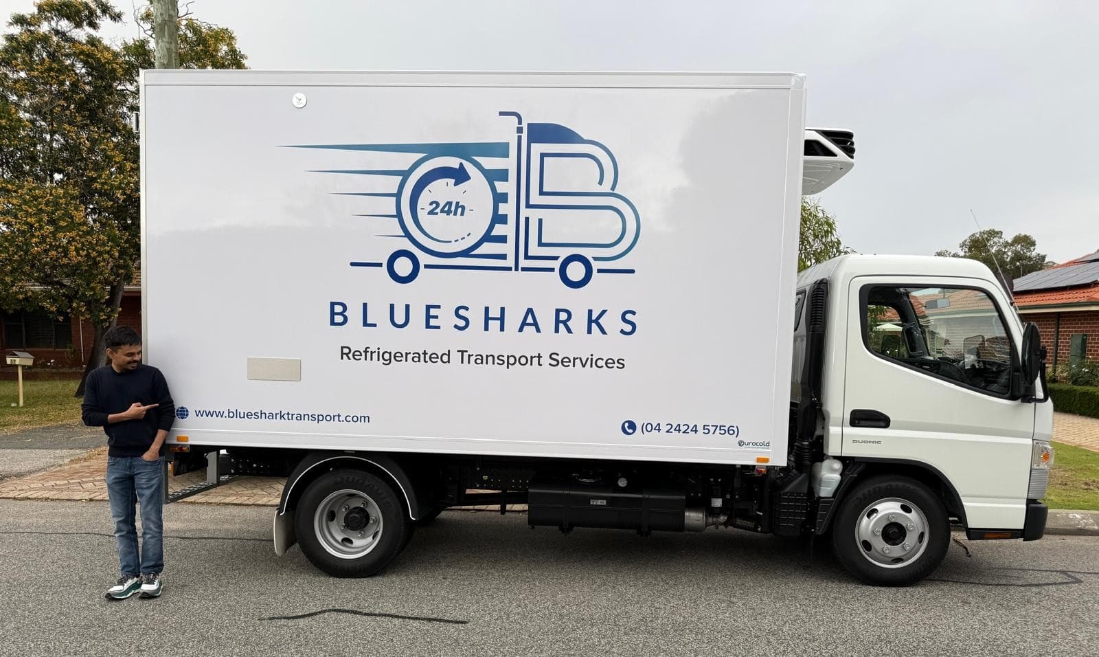 Bluesharks24H branded refrigerated truck with team member